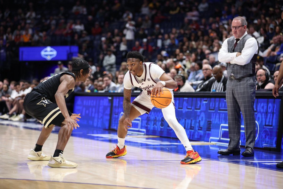 Texas A&M Aggies guard Wade Taylor IV dribbles the ball against a Vanderbilt defender during the SEC tournament in Nashville, Tennessee. 